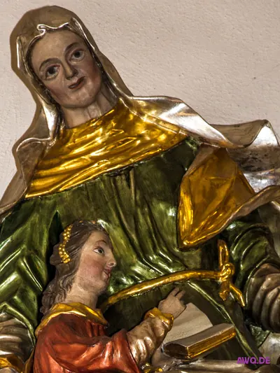 Farbige Figurengruppe: die heilige Anna unterrichtet die junge Maria, die ein aufgeschlagenes Buch hält