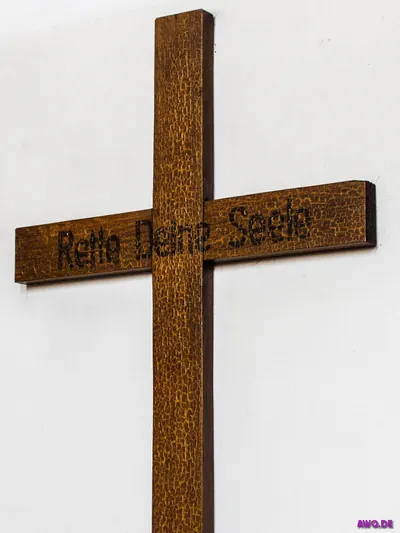 Schlichtes Holzkreuz mit eingebrannter Aufschrift „Rette Deine Seele“